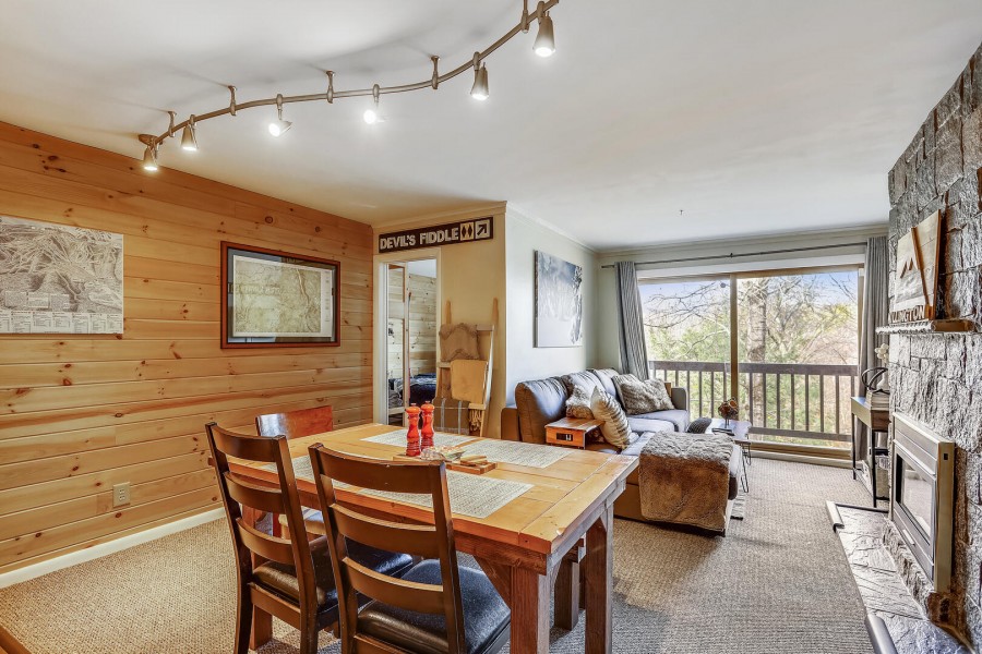 Interior of Whiffletree F6, a vacation rental located in Killington, VT. Featuring a furnished kitchen + living room area